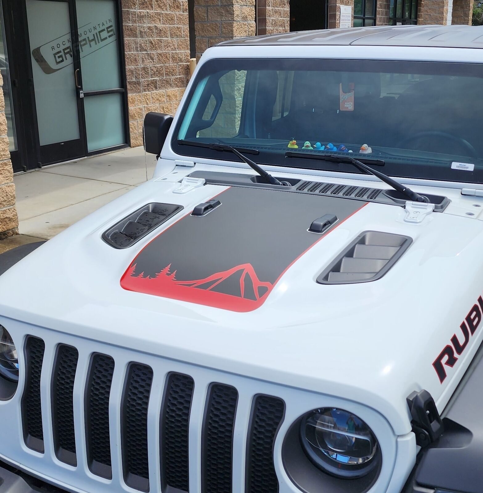 white rubicon with black and red mountains and forest graphic on hood