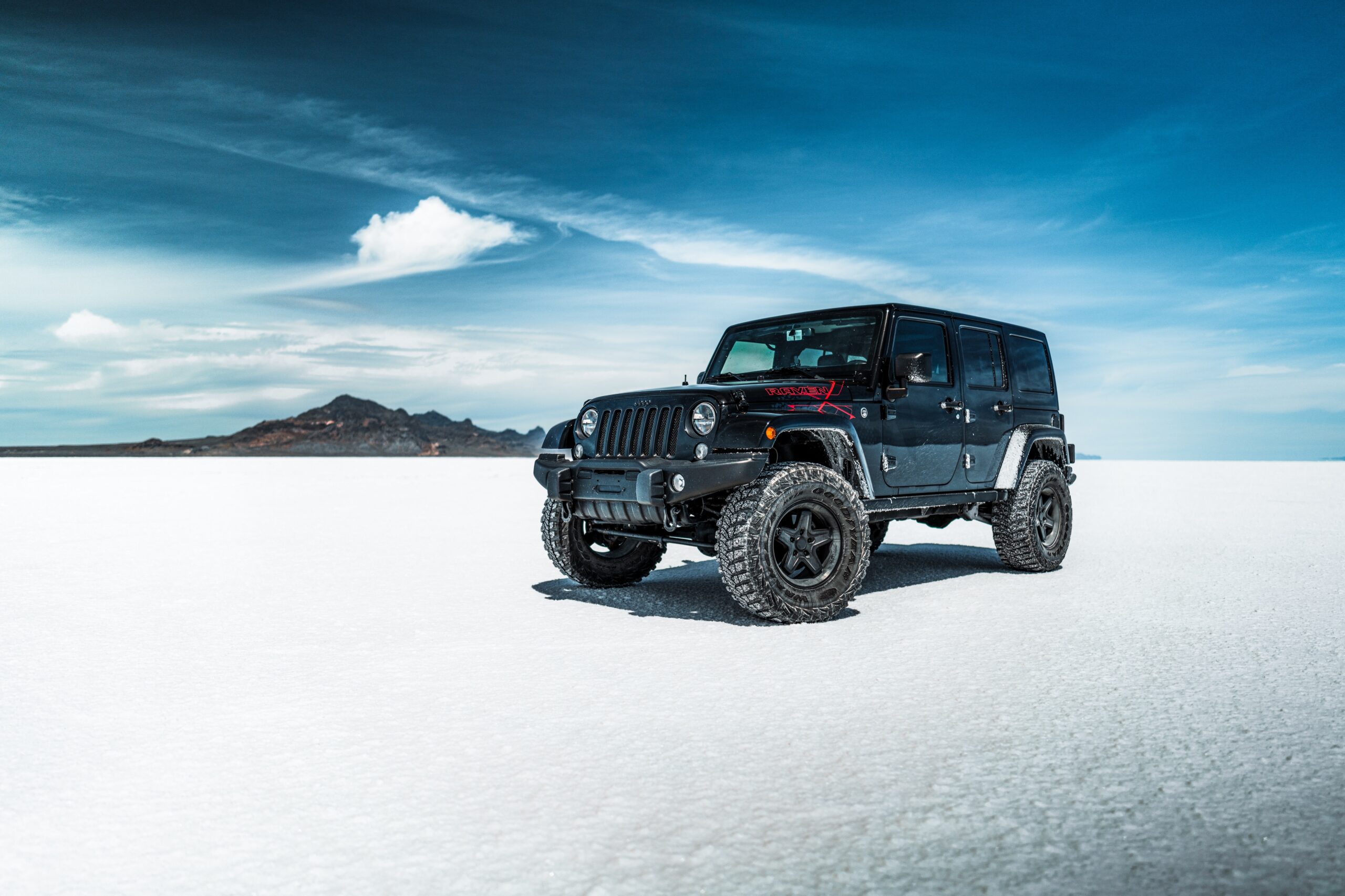 black Jeep Wrangler in snow off roads